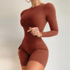 Women's brown knit slim-fit sports jumpsuit with long sleeves, perfect for yoga and fitness activities.