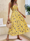 Printed Sleeveless Sling Dress in yellow floral pattern worn casually with a bag, showcasing a slim fit silhouette.