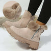 Women's short snow boots in beige, featuring plush lining, zipper detail, and thick rubber sole for winter comfort.