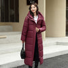 Women's long burgundy down puffer jacket with hood for winter, casual style, and warm comfort.