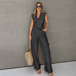 Female model wearing a women's two-piece asymmetric vest overalls in gray, showcasing a stylish and modern design.