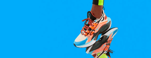 Colorful athletic shoes in action against a bright blue background, showcasing sporty style and vibrant design.